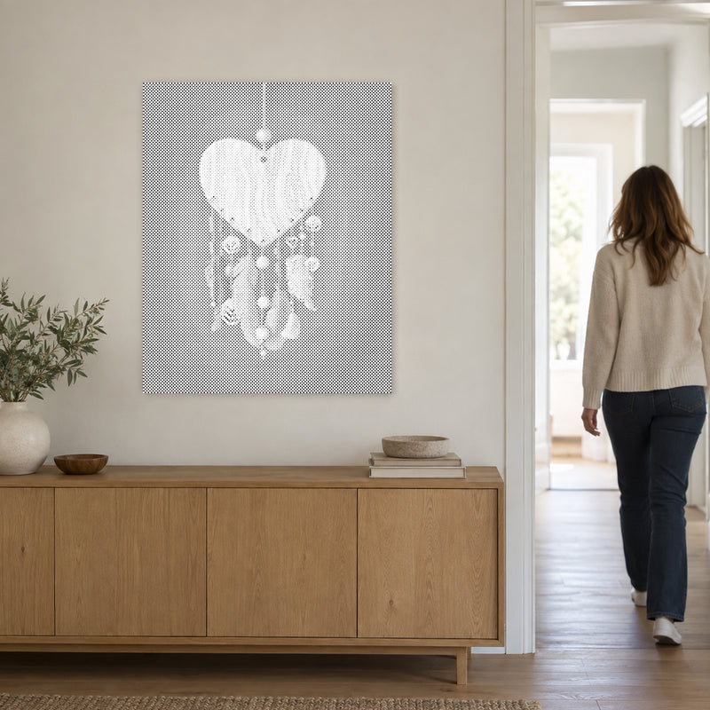 Dot-painting canvas “Heart Shaped Dreamcatcher”, on a light wall with a person walking through the doorway nearby.