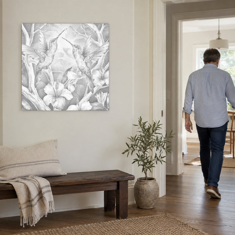 Dot-painting canvas “Hummingbirds Among Flowers”, on a light wall with a person walking through the doorway nearby.