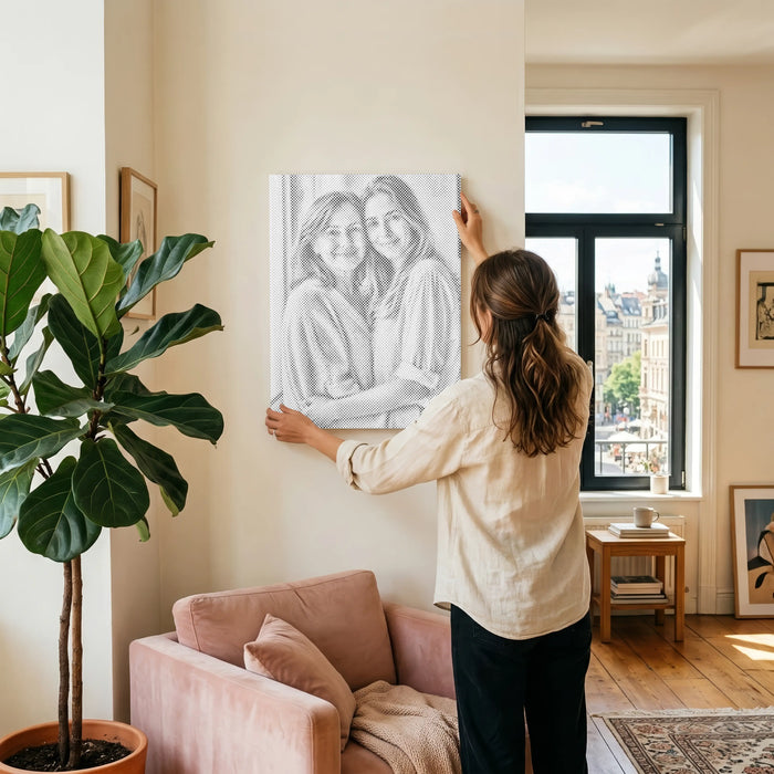 A custom dot painting of loved ones, displayed at home