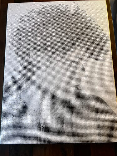 Nadja's finished 60 × 80 cm dot painting portrait in Classic Black, photographed at home