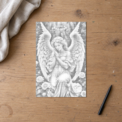 Dot-painting canvas “Angel with Delicate Roses”, lying on an oak worktable beside a black marker.