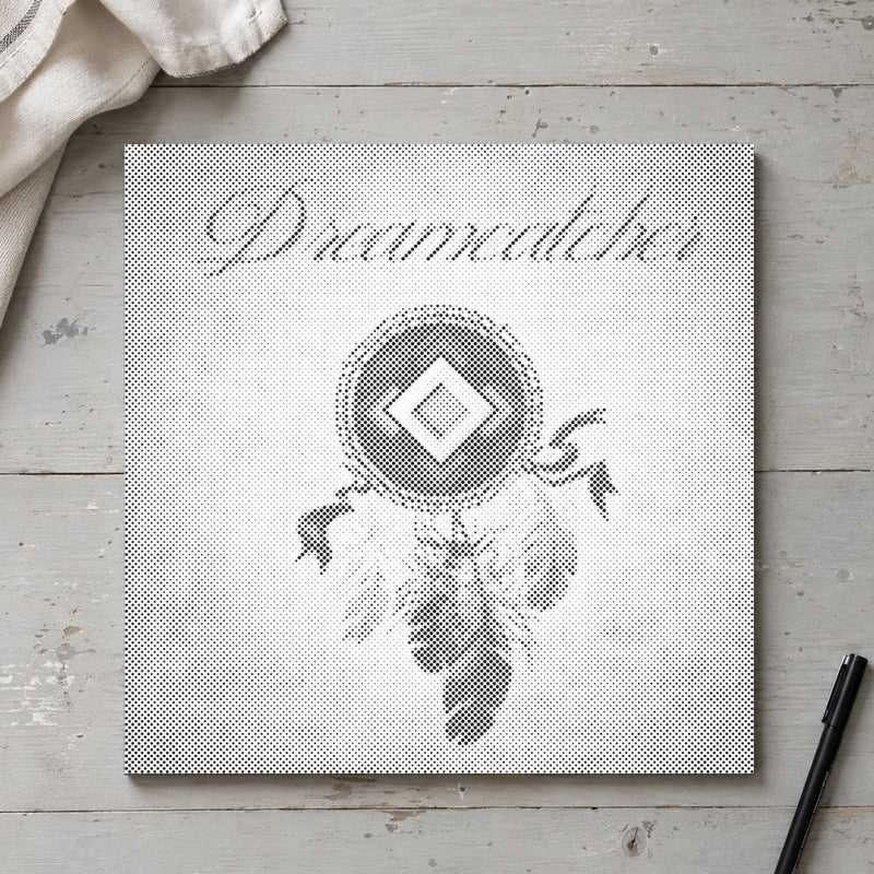 Dot-painting canvas “Dreamcatcher with Feathers”, seen from above on a worktable in soft daylight.