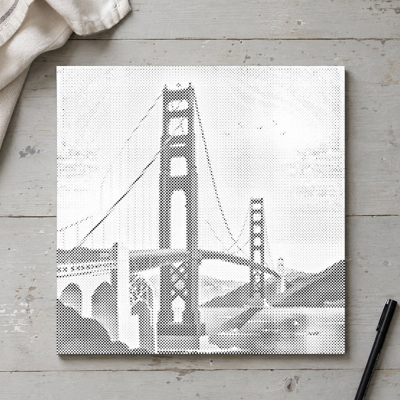 Dot-painting canvas “Golden Gate Bridge”, seen from above on a worktable in soft daylight.