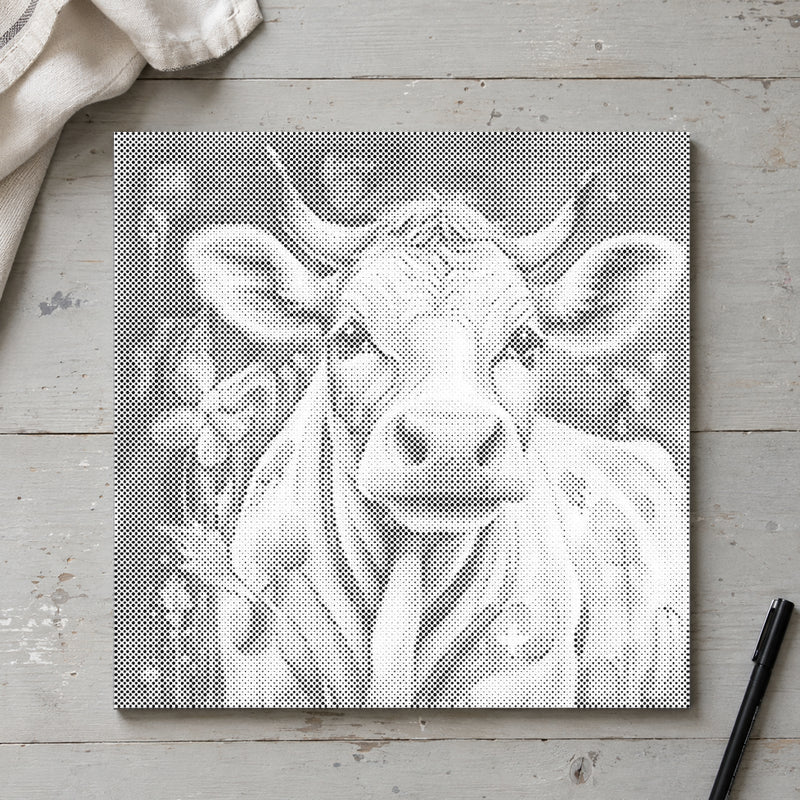 Dot-painting canvas “Happy Cow”, seen from above on a worktable in soft daylight.