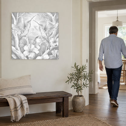 Dot-painting canvas “Hummingbirds Among Flowers”, on a light wall with a person walking through the doorway nearby.