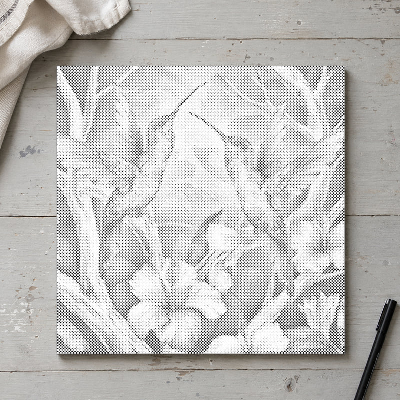 Dot-painting canvas “Hummingbirds Among Flowers”, seen from above on a worktable in soft daylight.