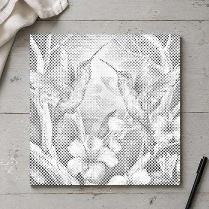 Dot-painting canvas “Hummingbirds Among Flowers”, seen from above on a worktable in soft daylight.