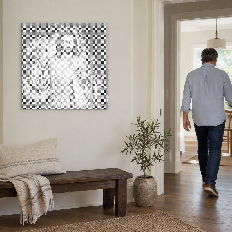 Dot-painting canvas “Jesus: The Sequel”, on a light wall with a person walking through the doorway nearby.